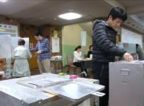 Japanese voters head to the polls as Typhoon Lan batters the country
