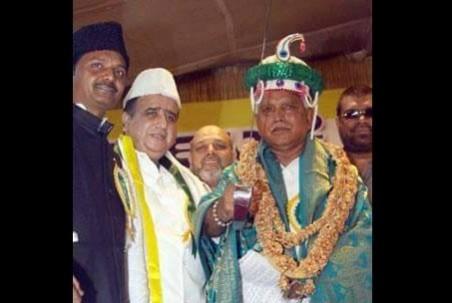 Karnataka State President for BJP, BS Yeddyurappa posing for a photograph with a cap and a sword in his hand at Tipu's Samadhi in Mysuru district, in December 2012 Yeddyurappa