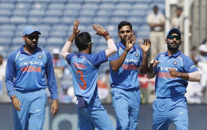 Bhuvneshwar Kumar (second right) celebrates with team-mates after dismissing Martin Guptill in the second ODI in Pune. Bhuvneshwar Kumar