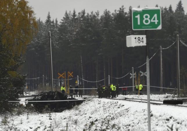 Rescue and military personnel are seen at the railroad crossing after a crash between a train and a military truck in Raasepori, Southern Finland, October 26, 2017 Finland train crash
