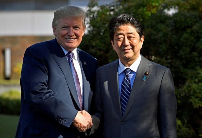 U.S. President Donald Trump (L) shakes hands with Japanese Prime Minister Shinzo Abe upon his arrival at the Kasumigaseki Country Club in Kawagoe, near Tokyo, Japan. Donald Trump and Shinzo Abe