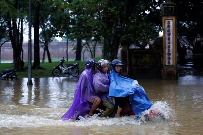People ride a motorcycle along flooded road after typhoon Damrey hits Vietnam in Hue city, Vietnam Vietnam typhoon