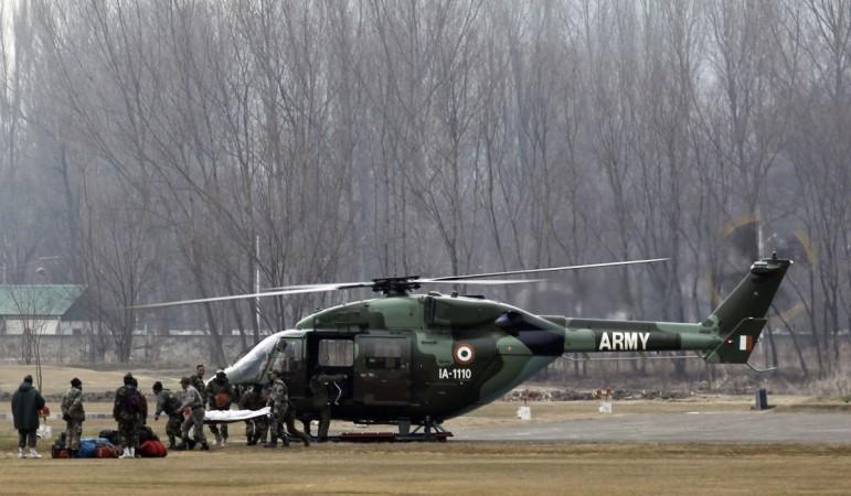 ndian army soldiers bring down the body of a colleague from a helicopter after an avalanche, before a wreath-laying ceremony in Srinagar February 25, 2012. Army helicopter