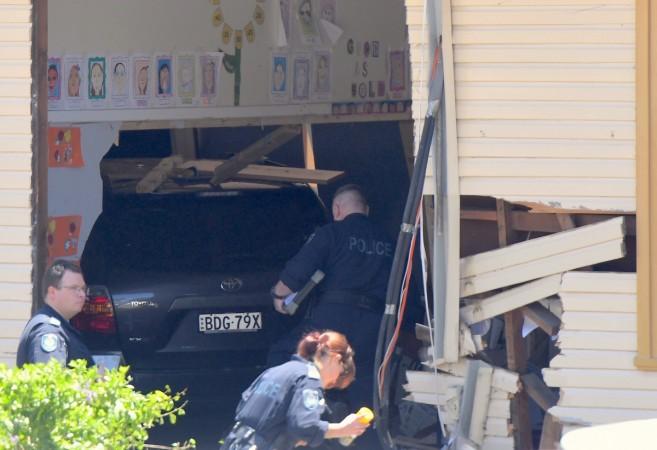 New South Wales emergency services personnel and police inspect a vehicle that crashed into a primary school classroom in the Sydney suburb of Greenacre in Australia, November 7, 2017 New South Wales
