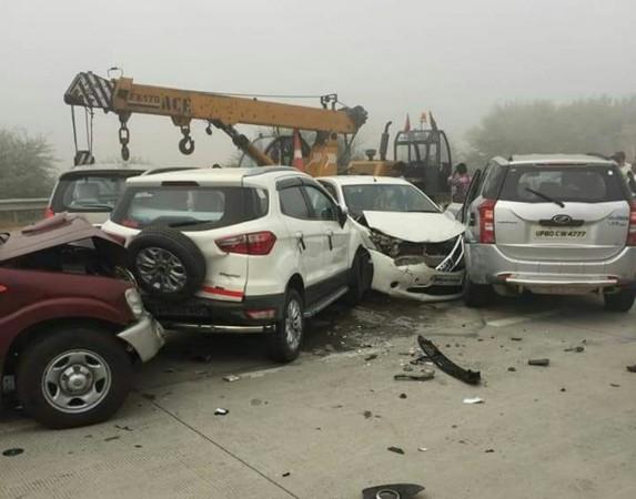 A crane being used to clear a pile of vehicles after moving vehicles rammed into each other as smog cover reduced visibility on the Yamuna Expressway in Mathura on Nov 8, 2017. Yamuna expressway- Noida-Agra