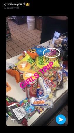 Kylie Jenner posted this on her snapchat story and fans couldn't help ignore the box of tampons among her junk binging cravings. kylie