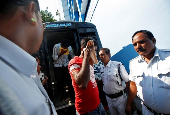 Police officers escort two men (faces covered) into court, who are accused of the gang-rape of an elderly nun, in <span>Kolkata</span>, India November 7, 2017 Kolkata nun rape