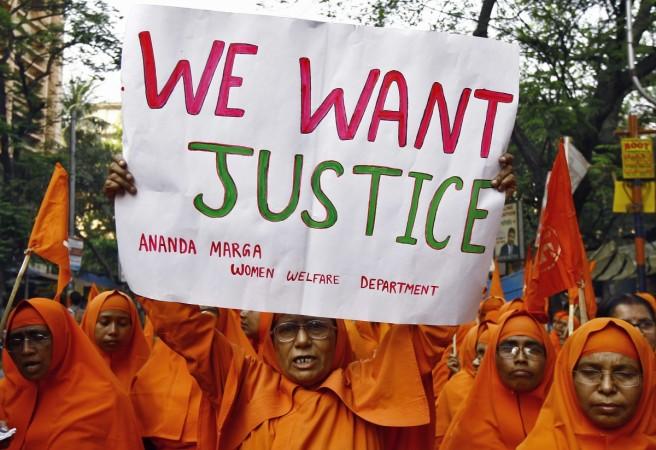 A Hindu nun holds a poster during a protest rally to show solidarity with the nun who was raped during an armed assault on a convent school, in <span>Kolkata</span> March 17, 2015. Hindu nun in kolkata