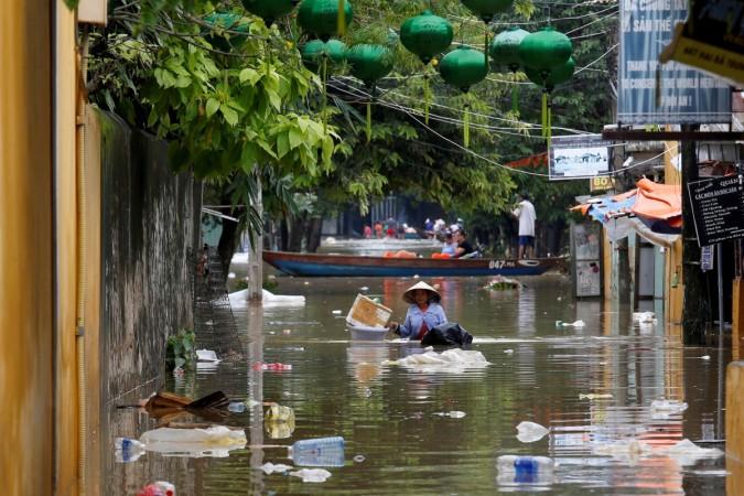 A woman wades along submerged by Typhoon Damrey Vietnam