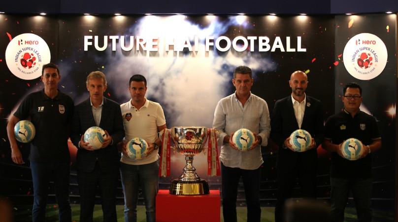 Mumbai City FC coach Alexandre Guimaraes, Bengaluru FC coach Albert Roca, FC Goa coach Sergio Lobera, Chennaiyin FC coach John Gregory, FC Pune City coach Ranko Popovic and Kerala Blasters assistant coach Thangboi Singto pose for a picture with the Hero ISL Trophy Indian Super League