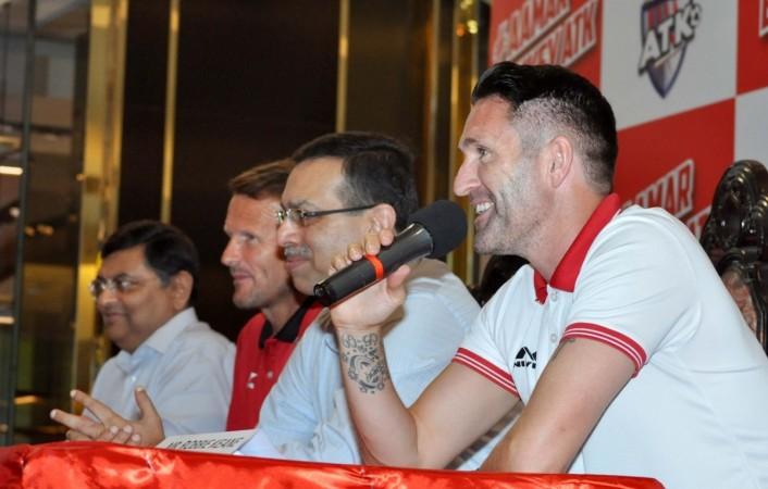 Atletico de Kolkata head coach Teddy Sheringham, captain Robbie Keane (on the mic) and co-owner Sanjiv Goenka during a press conference in Kolkata atk, isl 2017