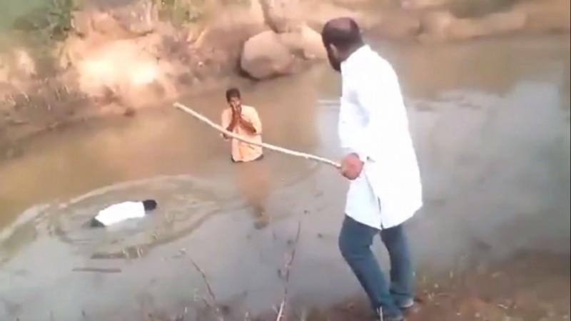 Two Dalit individuals forced to take a dip in a filthy pond, by an ex-BJP leader, Bharat Reddy, who is seen standing beside the pond in the video Reddy abuses Dalits