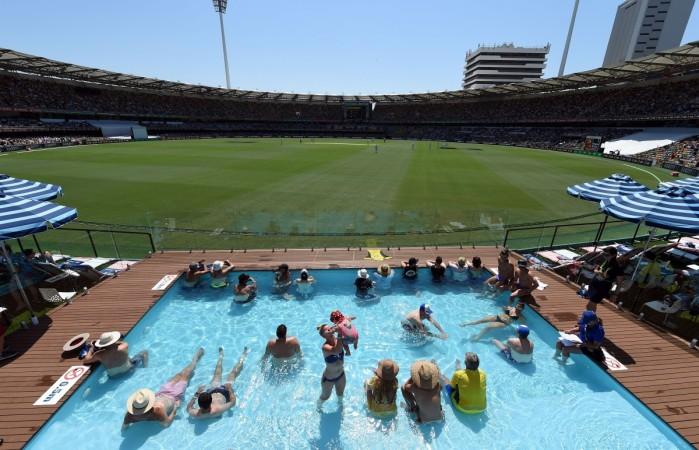 Spectators watch the first day-night cricket Test between Australia and Pakistan from the wading pool inside the Gabba stadium in Brisbane on December 15, 2016 ashes, gabba