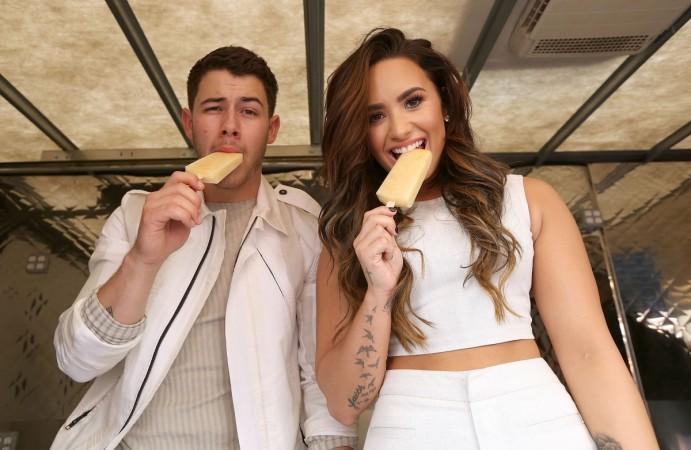 Nick Jonas and Demi Lovato hand out sweet treats and tickets to Demi Lovato's sold out show for Marriott Rewards Members in Los Angeles next week at TCL Chinese Theatre on September 17, 2016 in Hollywood, California. Nick Jonas, Demi Lovato