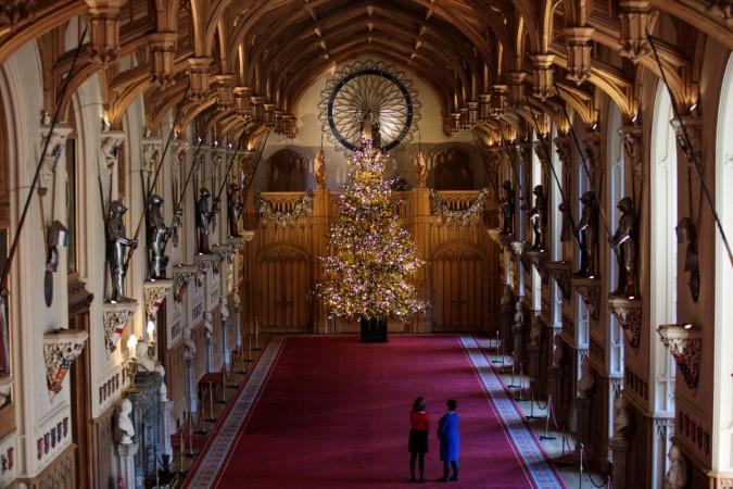 Employees pose with a 20ft Nordmann Fir tree from Windsor Great Park in St George's Hall which has been decorated for the Christmas period on November 23, 2017 in Windsor Castle, England. Christmas at Windsor Castle London