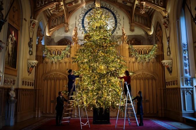 Employees pose with a 20ft Nordmann Fir tree from Windsor Great Park in St George's Hall which has been decorated for the Christmas. Christmas tree, Queen, Royal Family, England