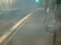 Dramatic footage shows woman pulled away from oncoming train with seconds to spare