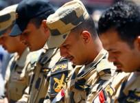 Egyptian army officers react during the funeral of officer Khaled al-Maghrabi, who was killed during a suicide bomb attack