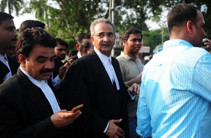 Indian lawyer Tanveer Ahmed Mir (C) leaves Allahabad high court after the acquital of his clients Rajesh and Nupur Talwar over the 2008 double murder of their daughter Aarushi and servant Hemraj Banjade in Allahabad on October 12, 2017. Tanveer Ahmed Mir