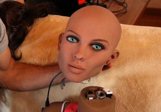 Catalan nanotechnology engineer Sergi Santos holds the head of Samantha, a sex doll packed with artificial intelligence providing her the capability to respond to different scenarios and verbal stimulus, in his house in Rubi, north of Barcelona, Spain, March 31, 2017. sex dolls 3