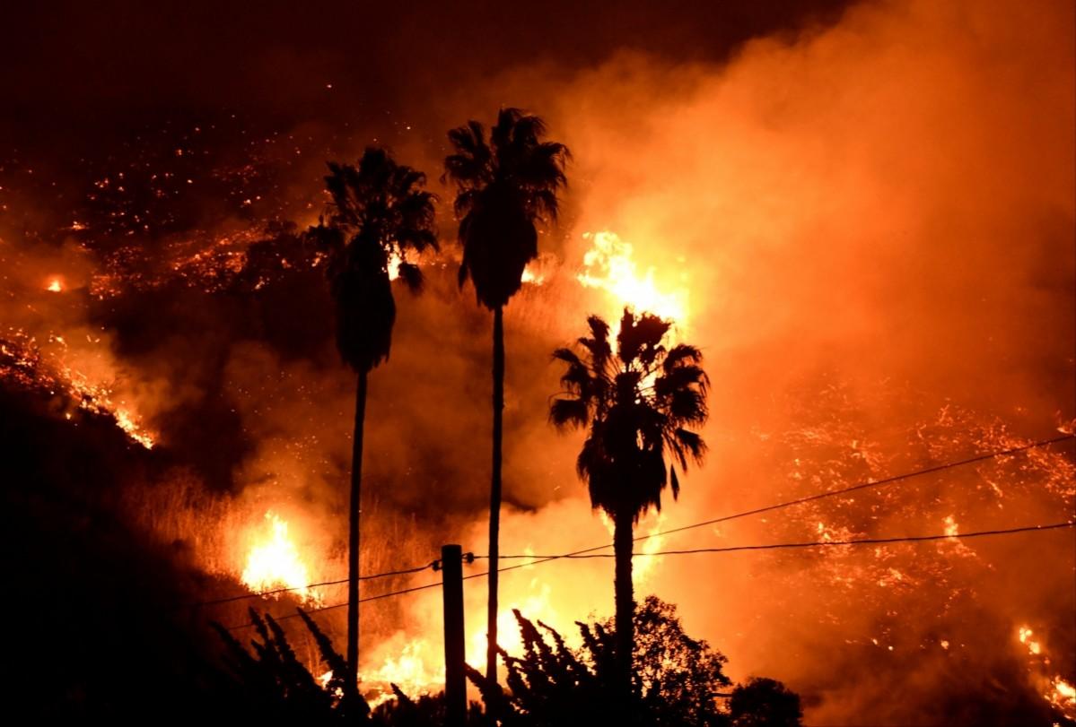Flames spread in a valley from a Santa Ana wind-driven brush fire called the Thomas Fire near Ventura, California, December 5, 2017 California wildfire
