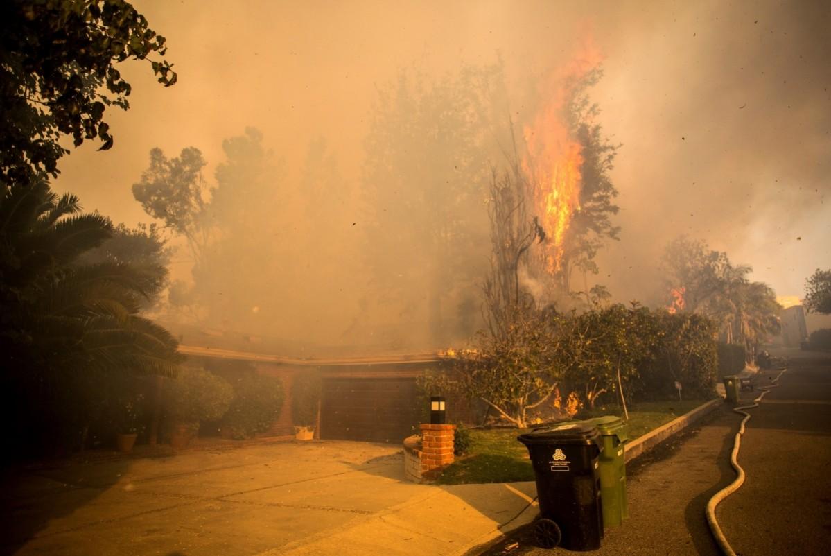 A house is threatened by wildfire along Linda Flora Drive during the Skirball Fire in Los Angeles, Skirball Fire