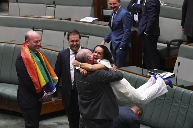 Liberal MP Warren Entsch lifts up Labor MP Linda Burney as they celebrate the passing of the Marriage Amendment Bill in the House of Representatives at Parliament House in Canberra December 7, 2017. australia gay marriage 3