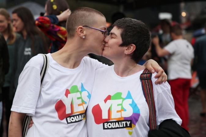 Tracy Clark and her partner Justyna Greinart embrace as they gather with a crowd of people to watch a large television screen at Federation Square as it is announced that same-sex marriage will be legal in Australia with Parliament agreeing to change the Marriage Act and end the ban on gay and lesbian couples marrying on December 7, 2017 in Melbourne, Australia. The historic bill was passed on the final day of parliamentart sitting for 2017. The legislation means same-sex couples will now be able to be legally married in Australia. Australians voted 'Yes' in the Marriage Law Postal Survey for the law to be changed in November. australia gay marriage 4