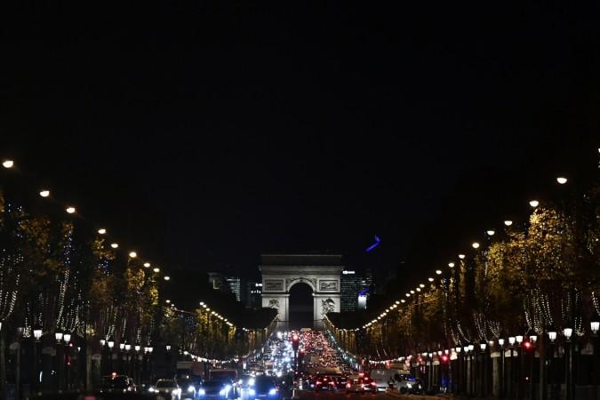 A picture taken on November 22, 2017 shows Champs-Elysee Avenue illuminated with the Christmas lights with the Arc de Triomphe in the background, in Paris Arc de Triomphe