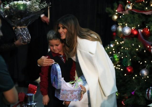 First lady Melania Trump hugs Damian Contreras during a visit to Children's National Medical Center, on December 7, 2017 in Washington, DC. First ladies dating back to Jacqueline Kennedy have made the annual visit to the Washington area hospital during the holiday season. melania 2