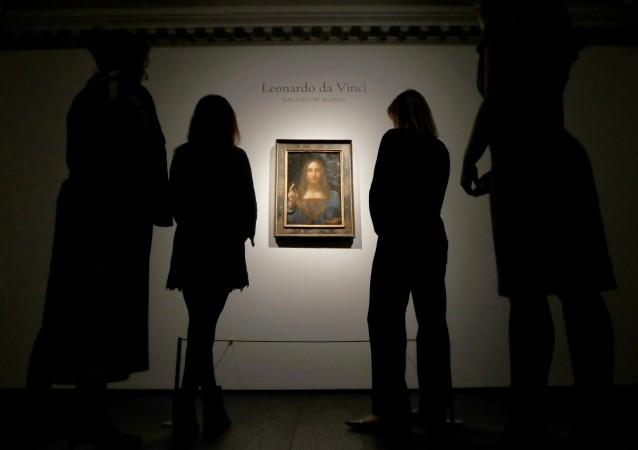 Members of Christie's staff pose for pictures next to Leonardo da Vinci's Members of Christie's staff pose for pictures next to Leonardo da Vinci's