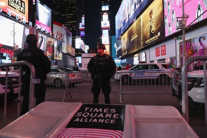 A policeman stands guard in Times Square not far from the site of a pipe bomb explosion Port Authority