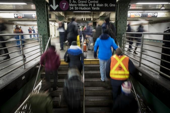 Commuters exit a train during the evening rush hour near the tunnel that connects the Times Square subway station to the Port Authority Bus Terminal Port Authority