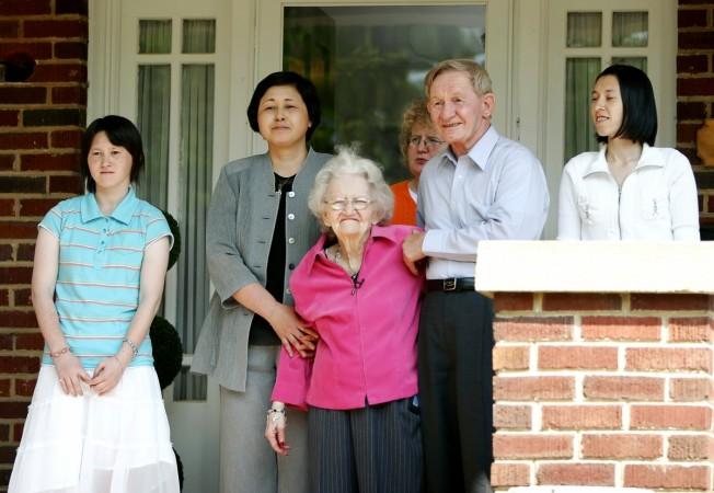 Charles Robert Jenkins (2nd R), a former U.S. Army sergeant who fled to North Korea in 1965, stands with his 91-year-old mother Patty Casper (C), daughter Brinda (K), wife Hitomi Soga (2nd L) and daughter Mika on the porch of his sister's home in Weldon, North Carolina June 14, 2005. Charles Robert Jenkins