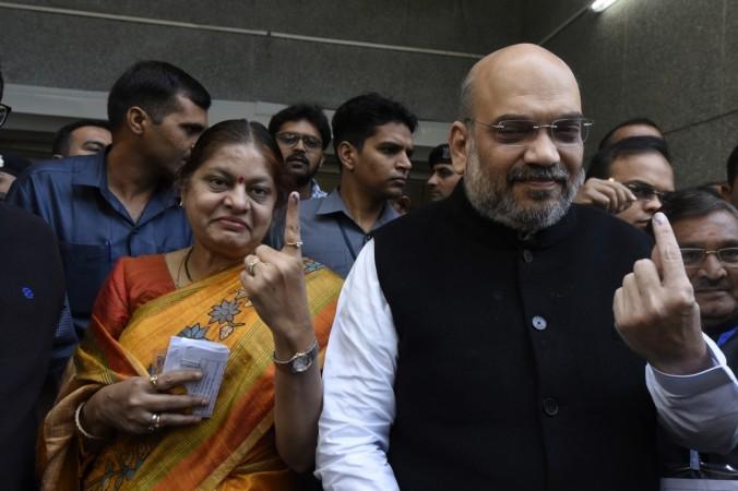 BJP President Amit Shah and his wife Sonal Shah show their fingers marked with phosphoric ink after casting their votes during the second and final phase of the Gujarat elections in Naranpura, Ahmedabad on Dec 14, 2017. Amit Shah Gujarat111