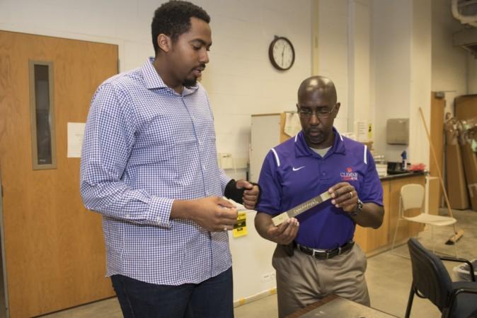 Oliver Myers (right) and mechanical engineering master's student Brandon Williams work with some of the smart material they are developing at Clemson University. Vehicles could get nerves