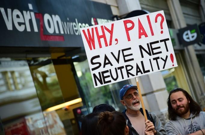 A small group of protestors supporting net neutrality protest against a plan by Federal Communications Commission (FCC) head Ajit Pai, during a protest outside a Verizon store on December 7, 2017 in Los Angeles, California. Demonstrations in support of net neutrality are planned nation-wide at hundreds of Verizon stores and other venues. net neutrality