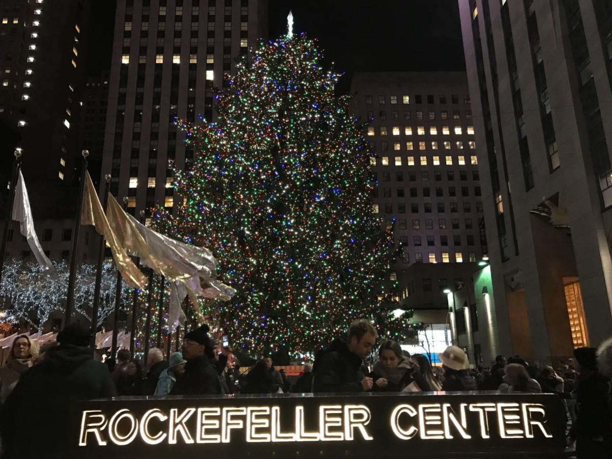 People walk past the Christmas Tree in Rockefeller Center in New York on December 1, 2017 Rockefeller Centre