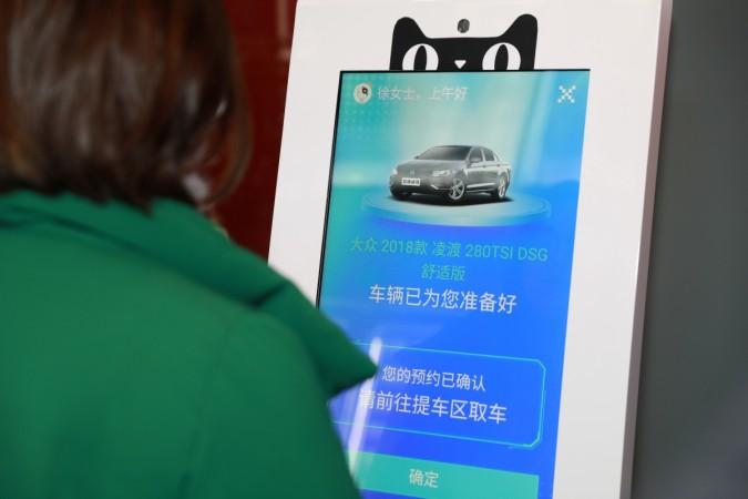 A customer goes through facial recognition system to access a car for test driving, at Alibaba's new Tmall car vending machine in Shanghai, China. Car Vending machine