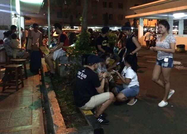 Residents gather outside their apartment blocks in Jakarta on early December 16, 2017, following after a strong earthquake measuring 6.5 on the Richter scale Java earthquake