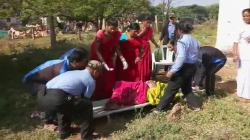 People take 30-year-old woman inside the Saheed Laxman Nayak Medical College and Hospital, after she gave birth to a baby in a drain. Odisha woman 221212