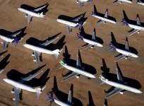 Old airplanes, including Boeing 747-400s, are stored in the desert in Victorville, California March 13, 2015.