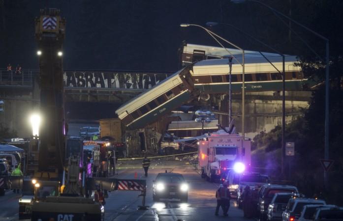 Work crews prepare to clear southbound I-5 lanes at the scene of an Amtrak train derailment on December 18, 2017 in DuPont, Washington Amtrak train derails