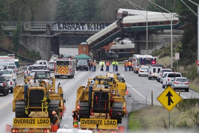 Rescue personnel and equipment are seen at the scene where an Amtrak passenger train derailed on a bridge over interstate highway Amtrak train derails