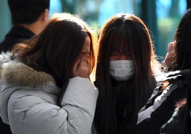 Tearful fans gather to visit the mourning altar for Kim Jong-Hyun, a 27-year-old lead singer of the massively popular K-pop boyband SHINee, at a hospital in Seoul on December 19, 2017. Kim Jonghyun