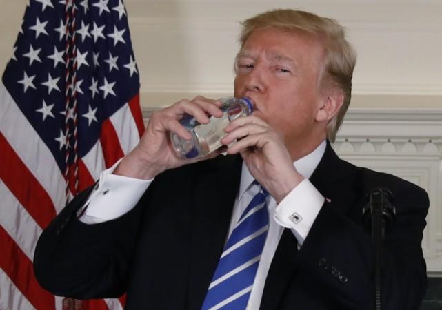 U.S. President Donald Trump takes a drink of water while speaking in the Diplomatic Room of the White House in Washington, U.S., November 15, 2017. Donald Trump