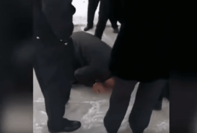 Li is then seen getting on his knees on the freezing ground and bowing three times as a sign of respect for his mother. prisoner 3