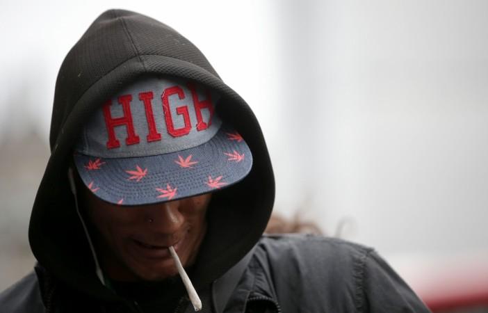 REPRESENTATIONAL PICTURE: A man stands with a hand-rolled cigarette in his mouth as he attends a 'Tea Party' organised by the United Patients Alliance (UPA), with food and drink products containing cannabis, opposite the Houses of Parliament in central London on October 10, 2017. Smoking