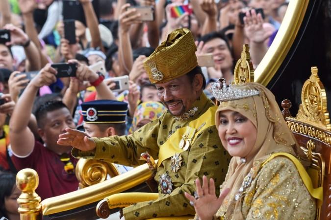Brunei's Sultan Hassanal Bolkiah and Queen Saleha ride in a royal chariot during a procession to mark his golden jubilee of accession to the throne in Bandar Seri Begawan on October 5, 2017. Brunei