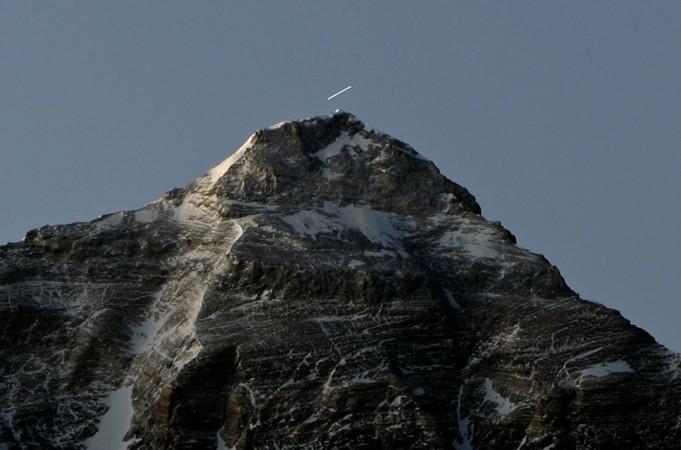 A time exposure shows a star leaving a trail over Mount Everest. everest height